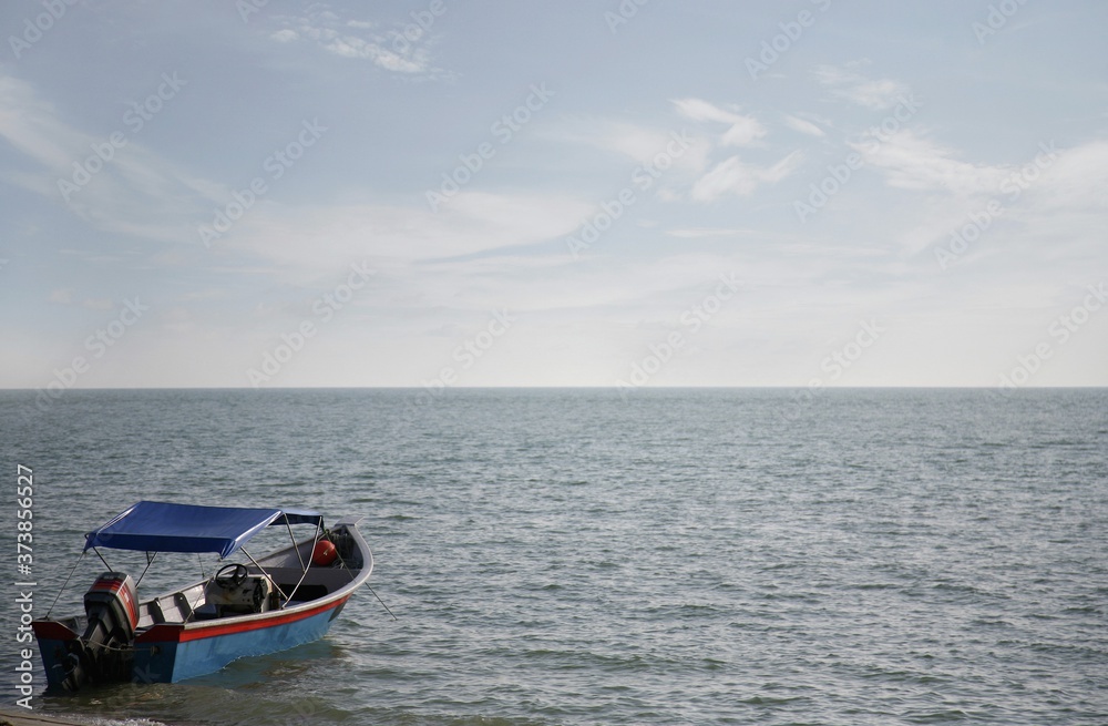 Naklejka premium Boat harboured at sea