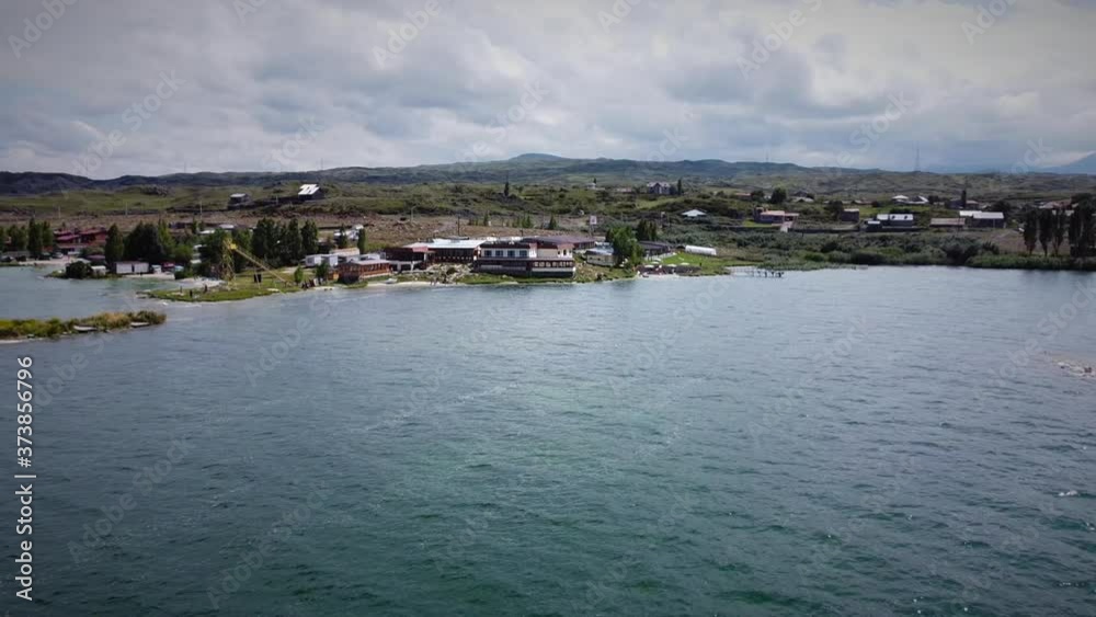 Drone Flying forward (zooming in) to the Coastline with the Hotel Building and beautiful mountains at the background Drone Flying forward (zooming in) to the Coastline with the Hotel Building and beautiful mountains at the background