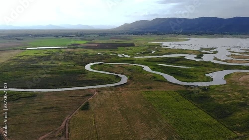 Wallpaper Mural Scenic landscape aerial view of field river and basin against a natural mountain, Drone shot tropical landscape with noise and grain processed Torontodigital.ca