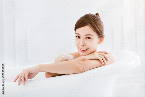 Beautiful young asian woman relaxing in bathtub