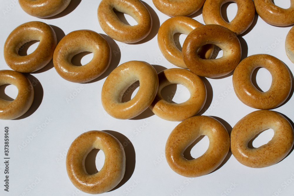 Brown round bagels baked goods on white background traditional russian bakery Brown round bagels baked goods on white background traditional russian bakery