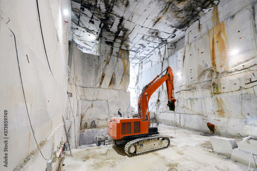 Large excavator inside a Carrara marble quarry Large excavator inside a Carrara marble quarry