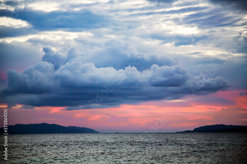 A pink sunset on a stormy sky on the Raja Ampat islands, Indonesia