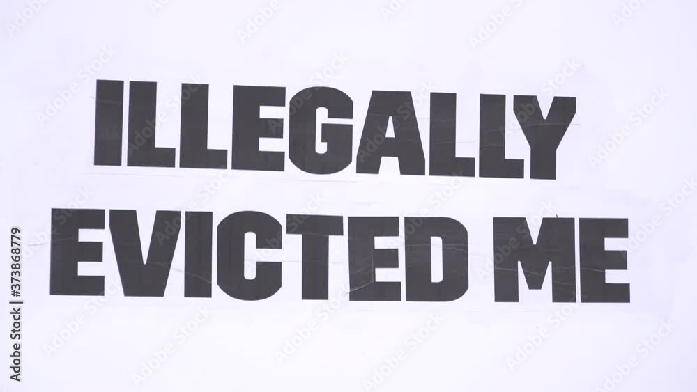 A message on a white cardboard placard says, “Illegally evicted me” on a housing protest opposing eviction during the Coronavirus pandemic. A message on a white cardboard placard says, “Illegally evicted me” on a housing protest opposing eviction during the Coronavirus pandemic.