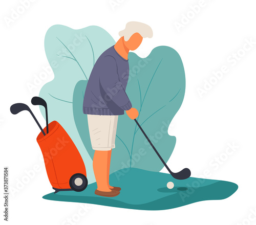 Senior man playing golf hitting ball, active pensioner