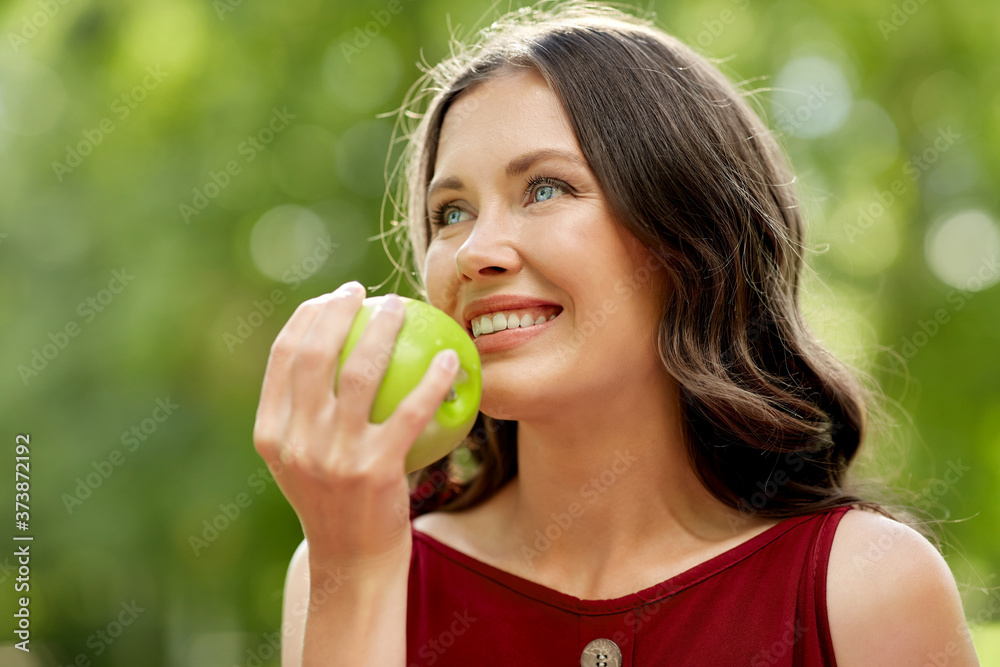 healthy eating, dental and people concept - portrait of happy woman with green apple at summer park healthy eating, dental and people concept - portrait of happy woman with green apple at summer park