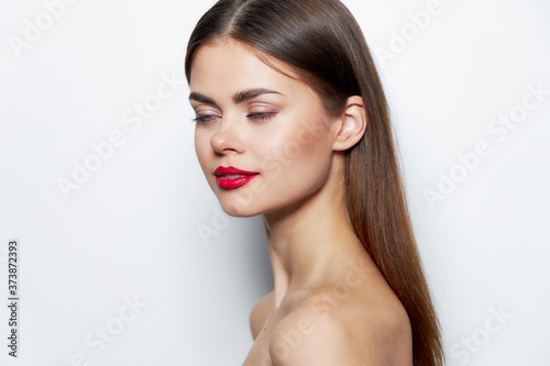 Girl bright makeup Nude shoulders red lips closed eyes 