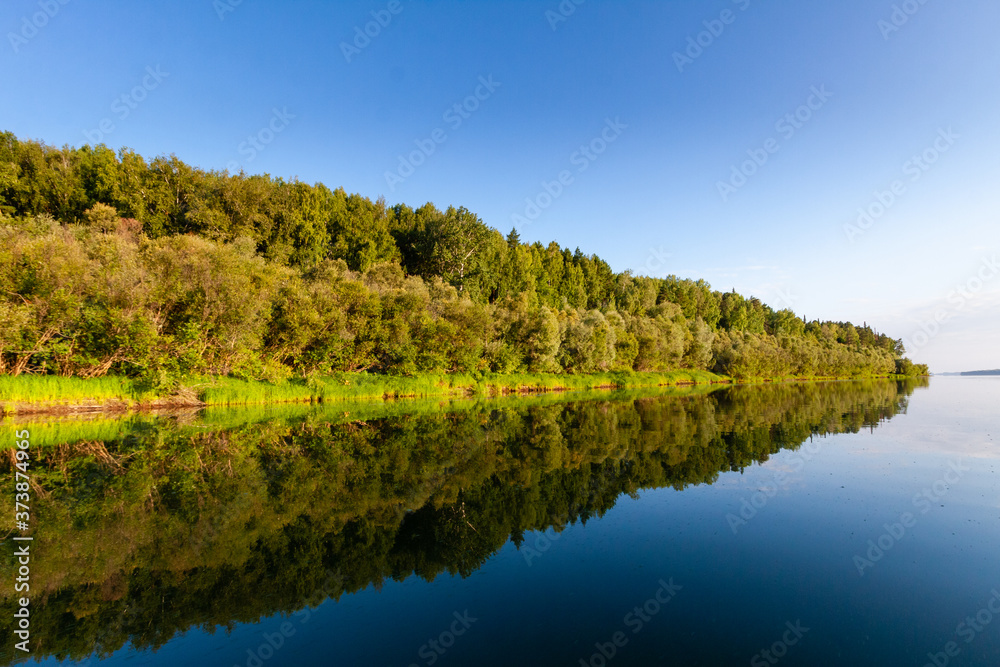 Siberian River Ob surrounded by Trees in Early morning in Russia in sunny weather during summer

