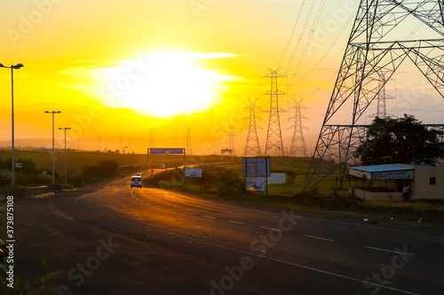 high-voltage power lines at sunset,high voltage electric transmission tower © Niks Ads