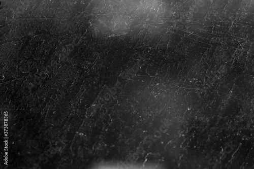 Highly textured backlighting. Light and shadow blurred grunge background, with traces of water drops, scratches and highlights. Monochrome texture.