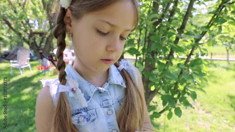 beautiful girl in a summer garden, children's holidays. little cute girl in a green garden. child's portrait beautiful girl in a summer garden, children's holidays. little cute girl in a green garden. child's portrait