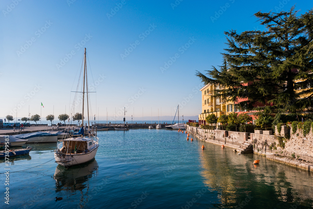 Small tourist port with private boats on Garda Lake, Sirmione, Brescia, Italy