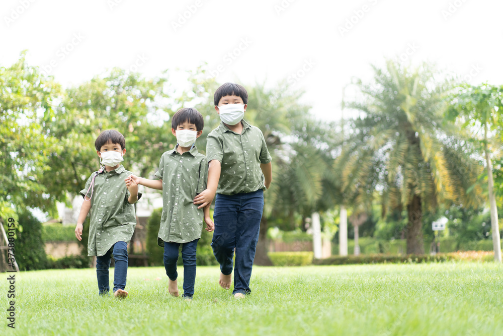 3 brothers are walking and playing in the garden in the evening.. 3 brothers are walking and playing in the garden in the evening..