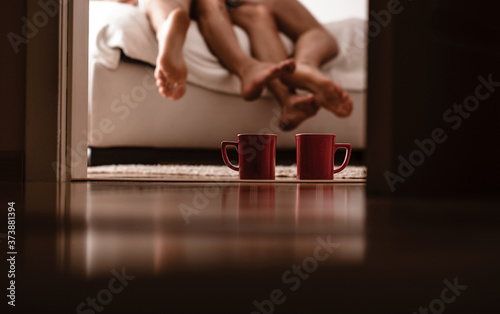 Couple in love lying in bed in hotel. Coffee time. Good morning. Couple in love. 