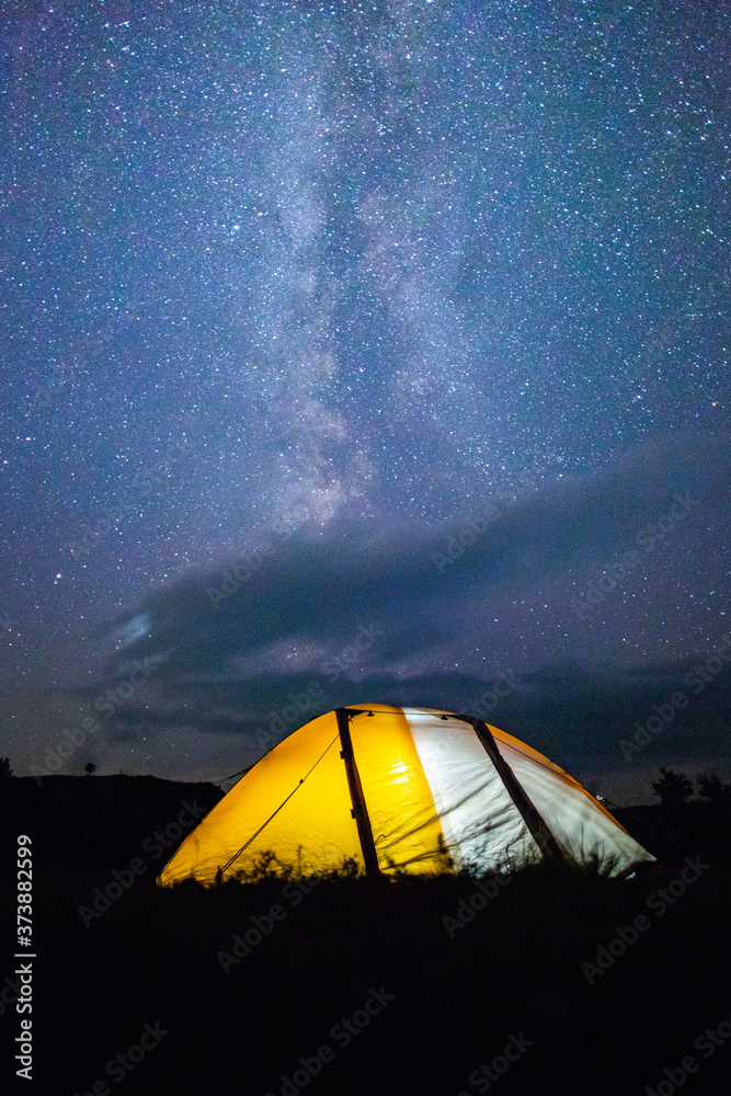 camping under starry sky illuminated tents at night