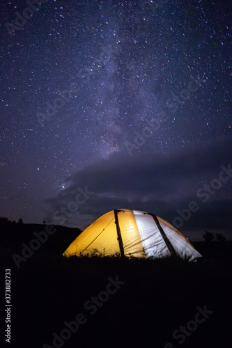 camping under starry sky illuminated tents at night
