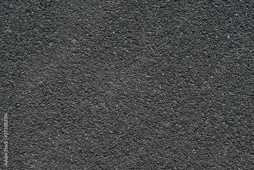 Texture of a rubber treadmill. Black floor in the stadium close up.