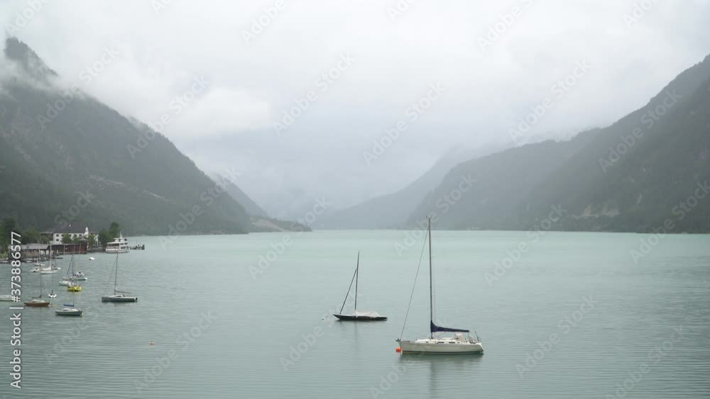 Achen Lake between the Austrian Alps with Panoramic View and Boats Achen Lake between the Austrian Alps with Panoramic View and Boats