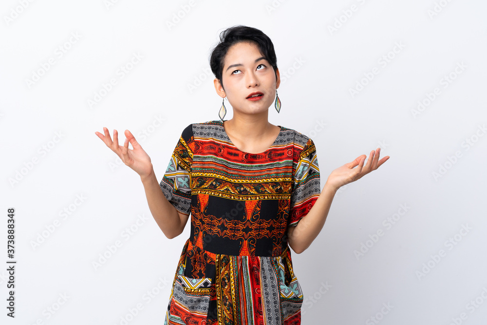 Young Asian girl with a colorful dress over isolated white background frustrated by a bad situation Young Asian girl with a colorful dress over isolated white background frustrated by a bad situation