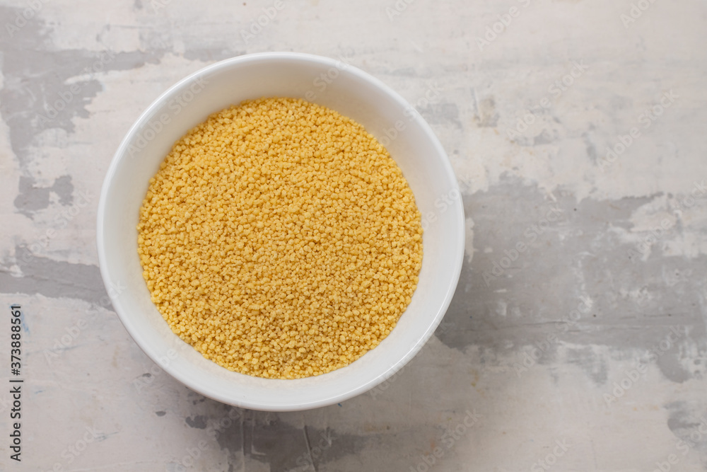 dry cous cous on white bowl dry cous cous on white bowl