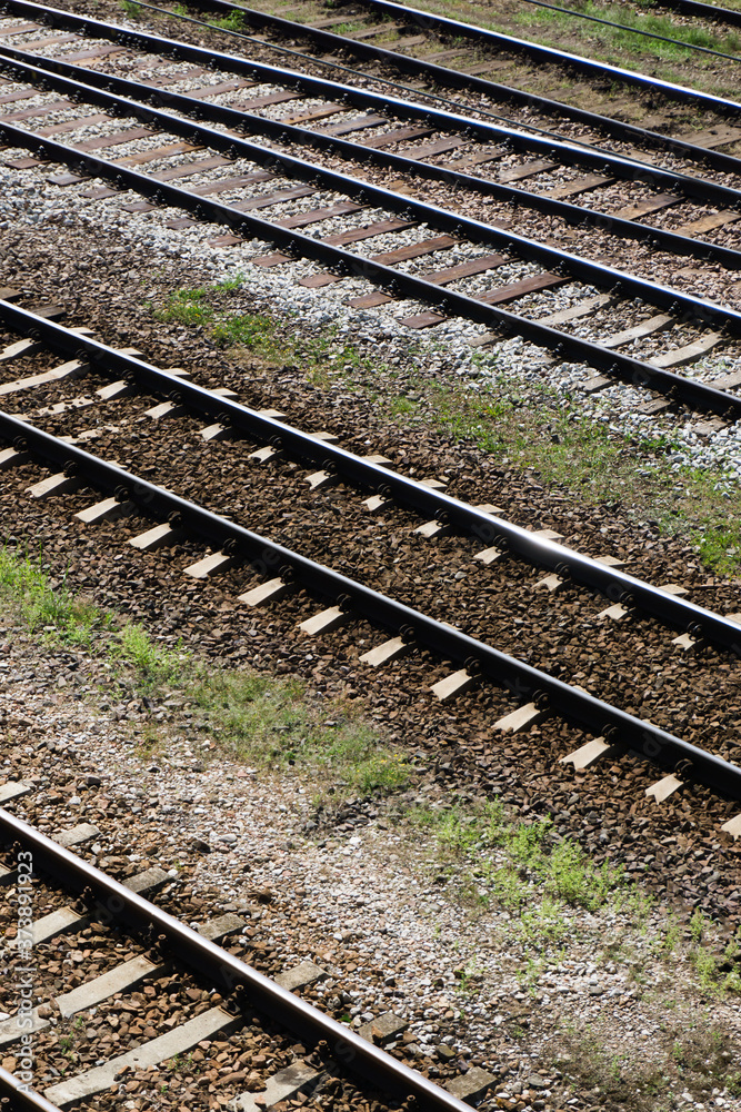 Railway top view background. Train transport industry. Vertical rail track texture. Good and cheap way of transportation for cargo. Old railroad wooden tie. Track ballast gravel made of crushed stone. Railway top view background. Train transport industry. Vertical rail track texture. Good and cheap way of transportation for cargo. Old railroad wooden tie. Track ballast gravel made of crushed stone.