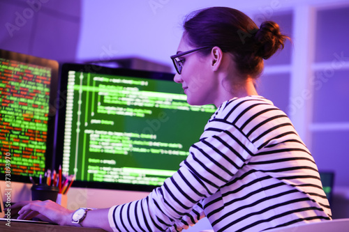 Female programmer working in office at night