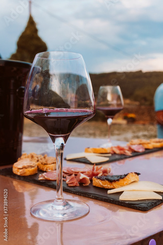 Detail of table with appetizer and red wine tasting on a traditional countryside experience.