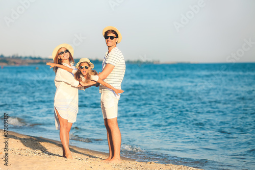 Happy family on sea beach a...