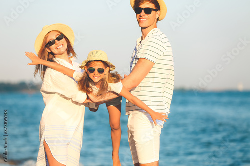 Happy family on sea beach a...