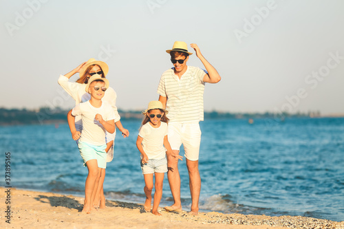 Happy family on sea beach a...