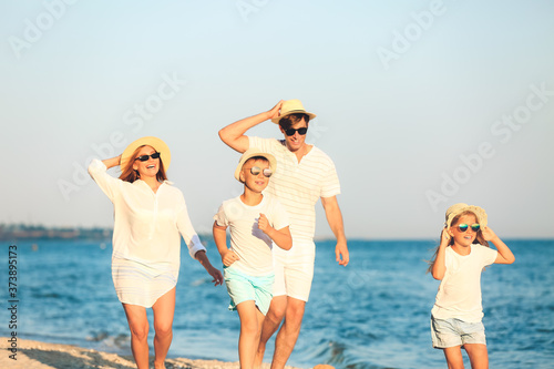 Happy family on sea beach a...