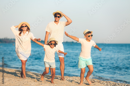 Happy family on sea beach a...