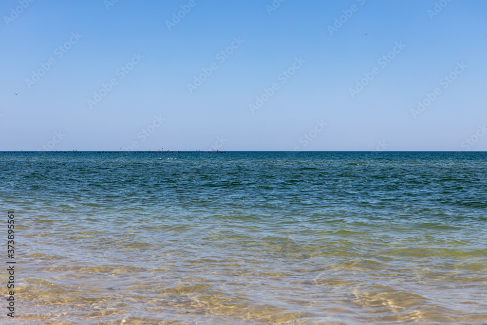Beautiful clear blue sea. Transparent water background and texture. Summer vacation with family