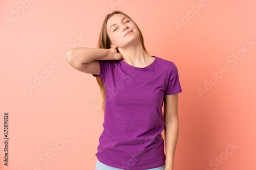Teenager Ukrainian girl isolated on pink background with neckache