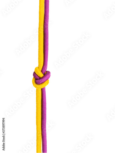 Varicolored rope with knot on white background (isolated).
