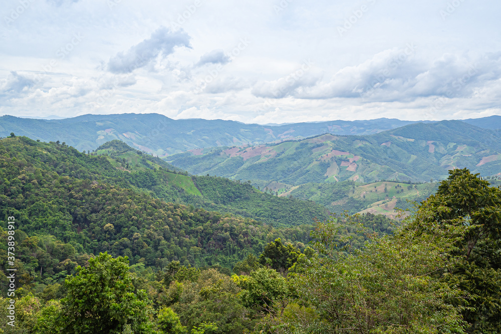 Scenic view of mountains against cloud sky Scenic view of mountains against cloud sky