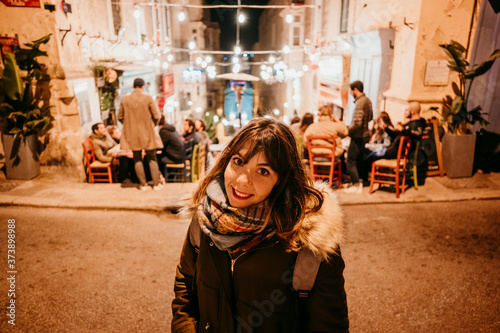 .Young tourist visiting the capital of malta at night. Portrait with night lighting of the city. Lifestyle © lubero