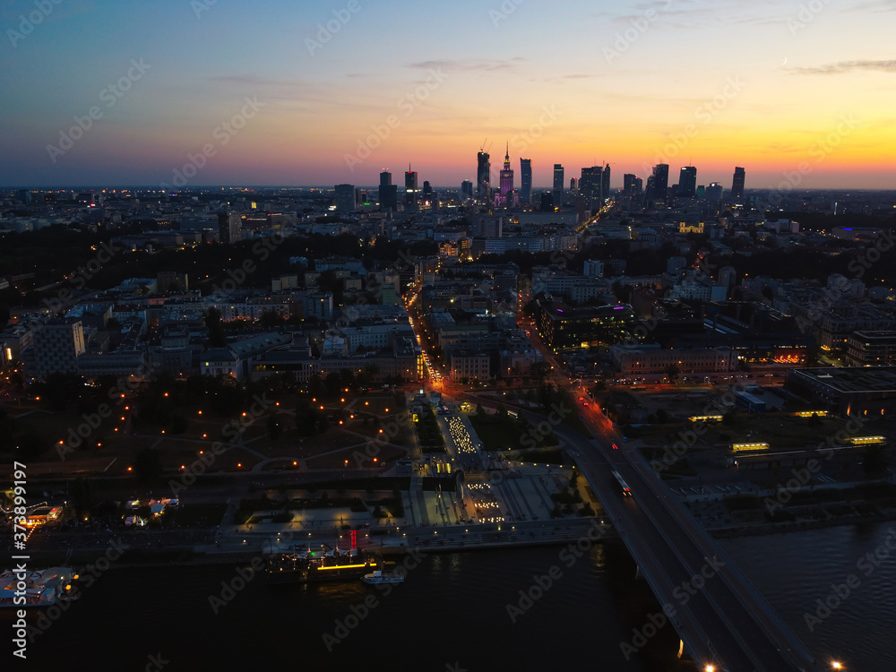 Capital cityscape and a suspension bridge over a large river. Drone, aerial view