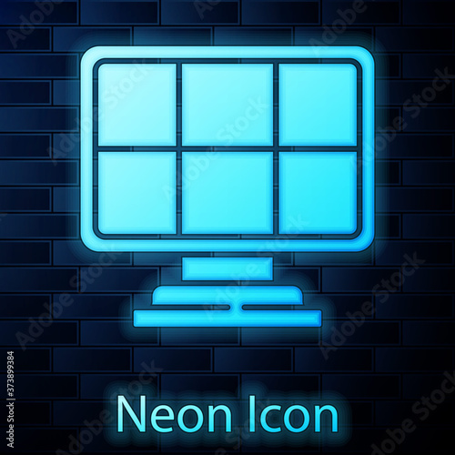 Glowing neon Solar energy panel icon isolated on brick wall background. Vector.