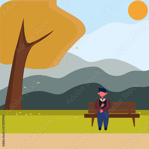 A young man sits on a bench in the Park and reads a book, a Man in an autumn Park