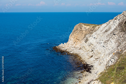 Summer beach day. Landscape of sea coast with beautiful rocks. © ita_tinta_