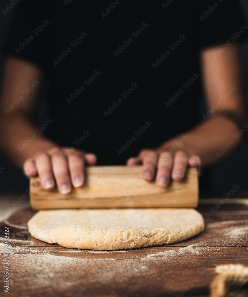 woman hands rolling dough