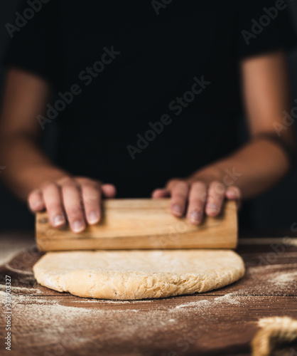 woman hands rolling dough