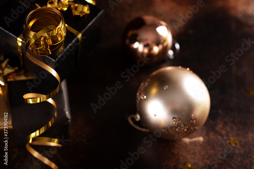 Christmas champagne, gas bubbles, confetti and blurry lights on a dark background
