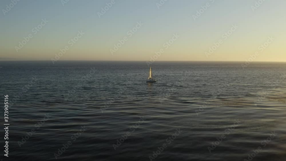 Drone Flies Above Sailboat Alone at Sea, Birds Eye Sunset View Drone Flies Above Sailboat Alone at Sea, Birds Eye Sunset View