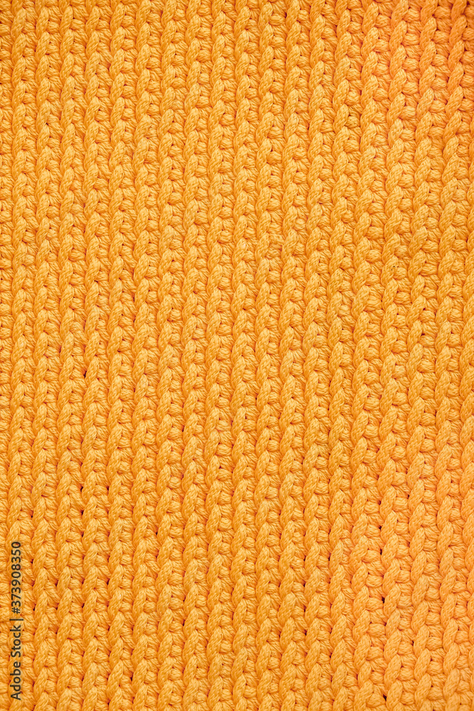 Fototapeta premium Orange knitted fabric texture background. Top view. Copy, empty space for text