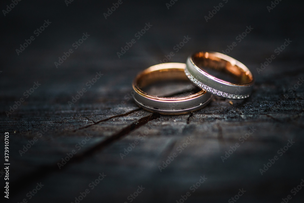 Two wedding rings on a wooden surface Two wedding rings on a wooden surface