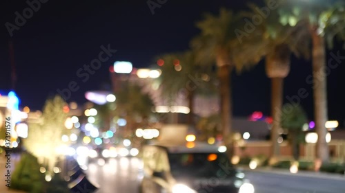 Defocused fabulous Las Vegas Strip boulevard, luxury casino and hotel, gambling area in Nevada, USA. Nightlife and traffic near Fremont street in tourist money playing resort. Neon lights of sin city.