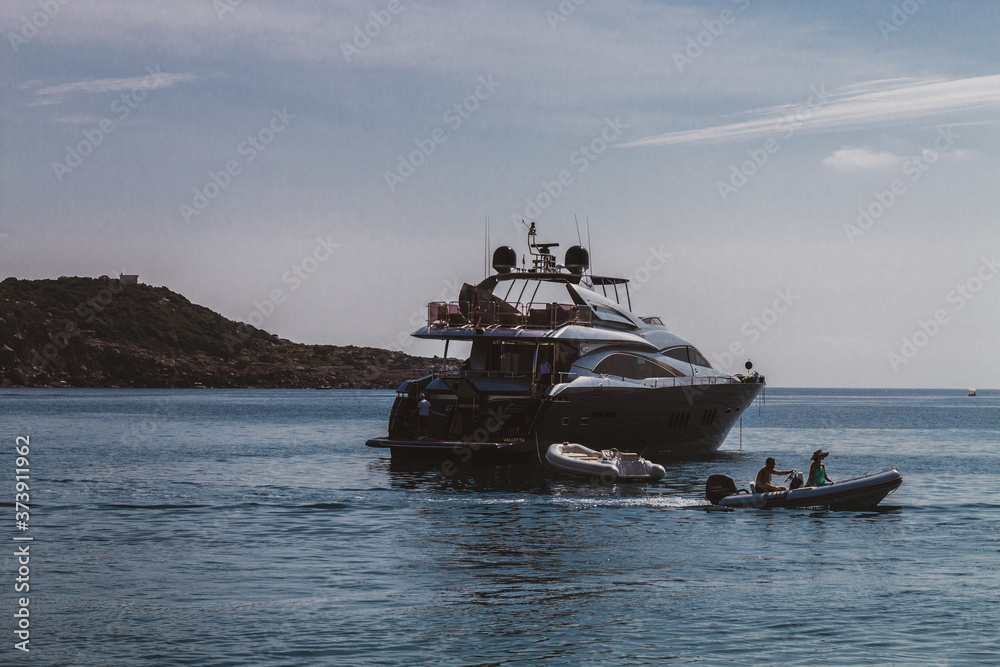 Ponza Island, Italy - 27 July 2019: People swimming and have fun around the cliffs in the blue sea of the island with their boat. Ponza, Italy Ponza Island, Italy - 27 July 2019: People swimming and have fun around the cliffs in the blue sea of the island with their boat. Ponza, Italy