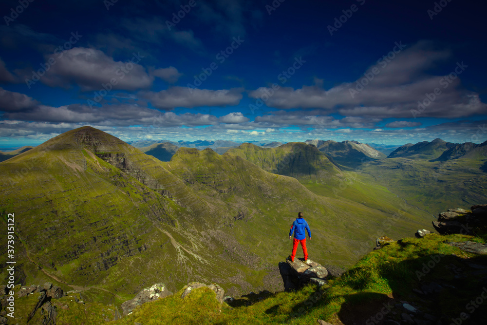 tourist taking in views over Torridon mountains, North west highlands, Scotland.